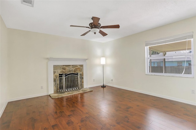 unfurnished living room with visible vents, baseboards, a ceiling fan, and wood finished floors