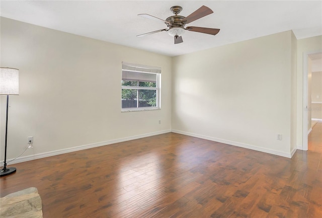 empty room with baseboards, a ceiling fan, and wood finished floors