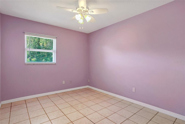 empty room featuring a ceiling fan and baseboards