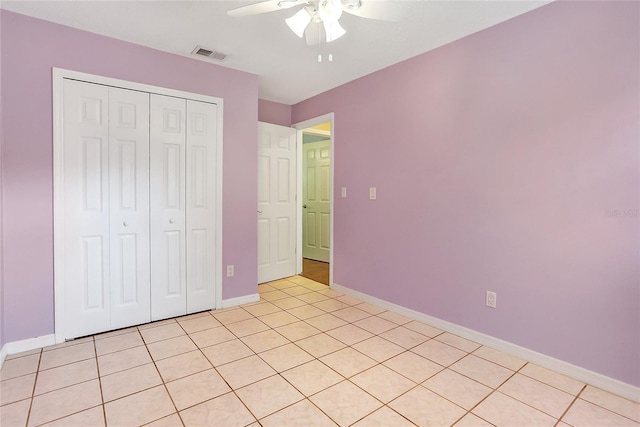 unfurnished bedroom with baseboards, visible vents, and a closet