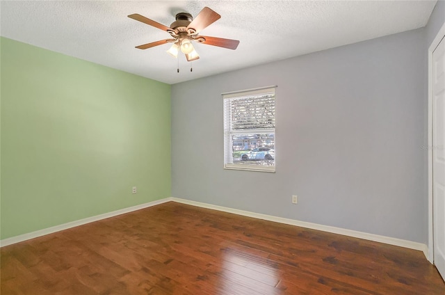 unfurnished room featuring ceiling fan, a textured ceiling, baseboards, and wood finished floors