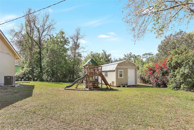 view of yard with a storage shed, an outbuilding, a playground, and central AC unit