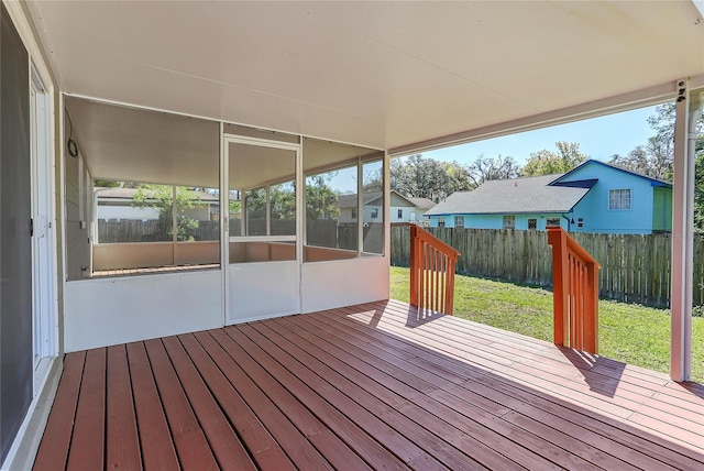 deck with a lawn and fence