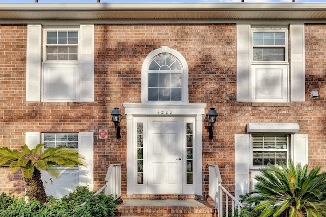 property entrance with brick siding