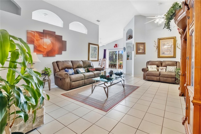 living room with light tile patterned floors, baseboards, visible vents, high vaulted ceiling, and ceiling fan