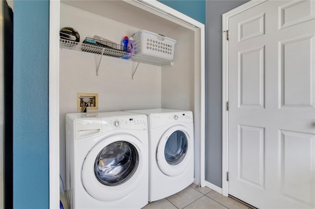 washroom with laundry area, light tile patterned floors, and independent washer and dryer