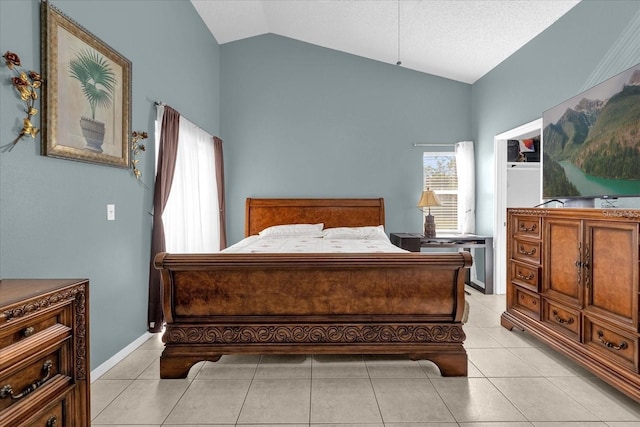 bedroom with vaulted ceiling and light tile patterned floors