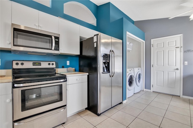 kitchen with light tile patterned floors, separate washer and dryer, light countertops, appliances with stainless steel finishes, and white cabinetry