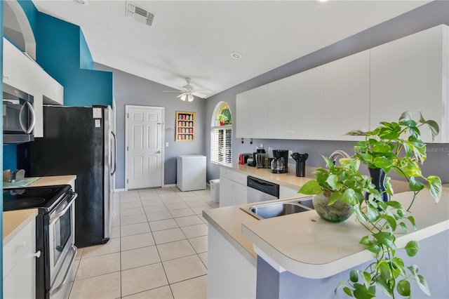 kitchen featuring visible vents, light tile patterned flooring, light countertops, white cabinets, and appliances with stainless steel finishes