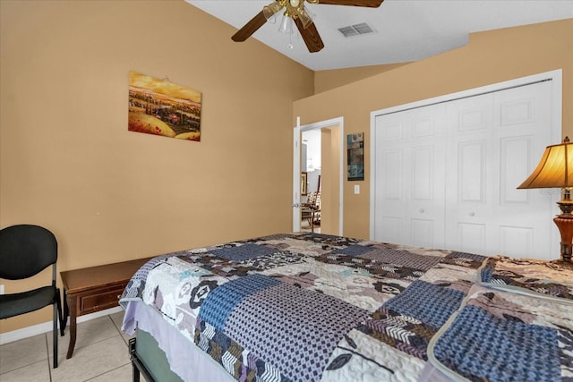 bedroom featuring visible vents, vaulted ceiling, light tile patterned floors, a closet, and a ceiling fan