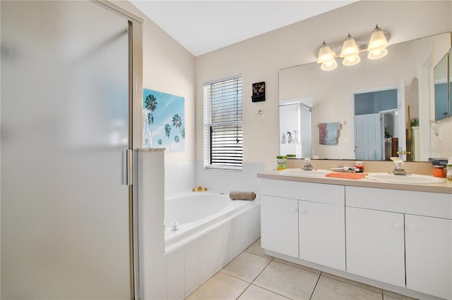 bathroom featuring a sink, a bath, a shower stall, and tile patterned floors