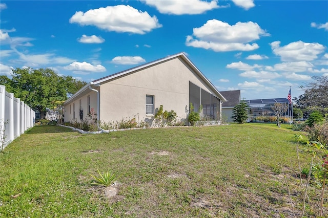 view of home's exterior featuring stucco siding, fence private yard, and a yard