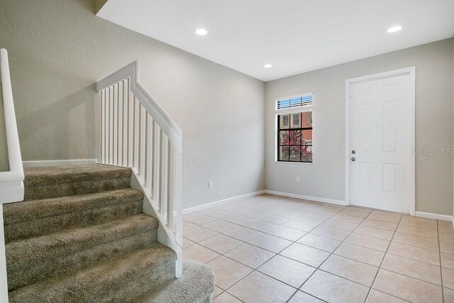 entrance foyer with light tile patterned flooring, stairway, recessed lighting, and baseboards