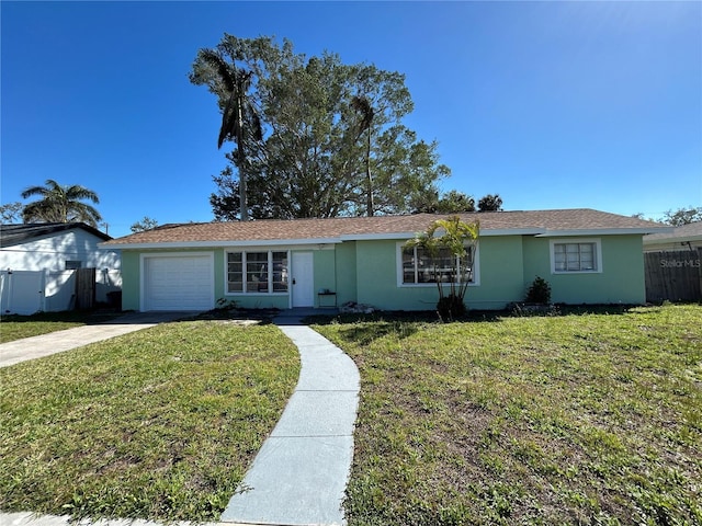 ranch-style home with fence, a front yard, stucco siding, a garage, and driveway