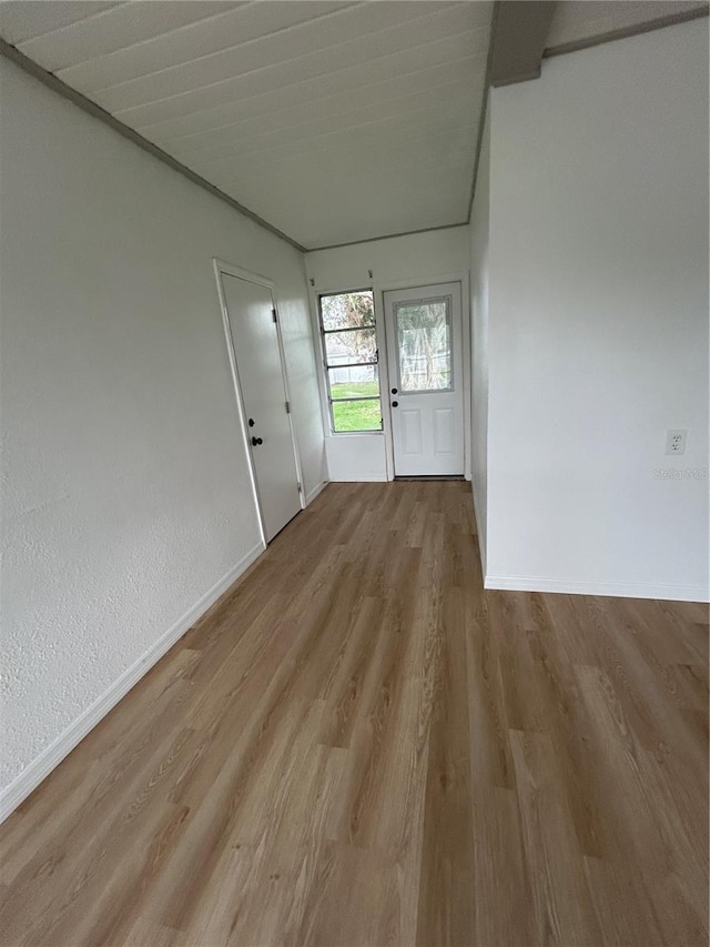 interior space featuring wood finished floors and baseboards