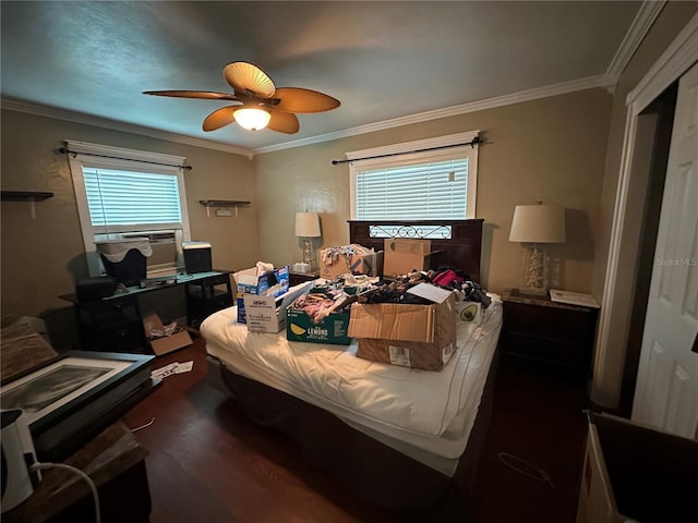 bedroom with a ceiling fan, crown molding, and wood finished floors