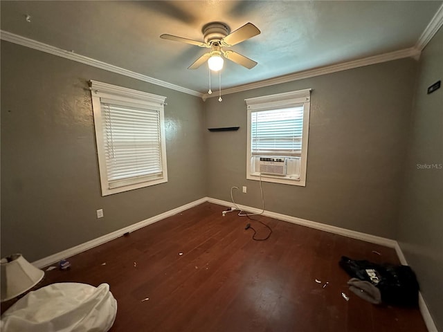 spare room with baseboards, dark wood-style flooring, and crown molding