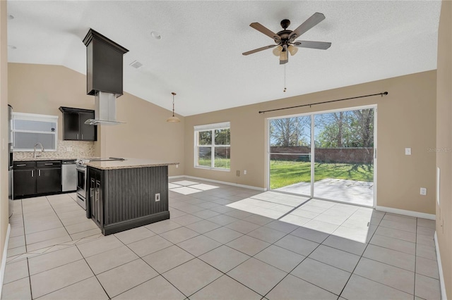 kitchen featuring dark cabinetry, stainless steel electric range oven, light tile patterned floors, and ceiling fan