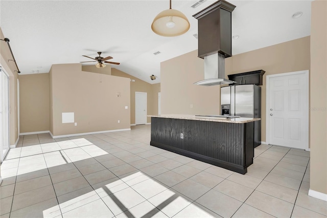 kitchen featuring ceiling fan, light countertops, stainless steel refrigerator with ice dispenser, light tile patterned flooring, and wall chimney exhaust hood