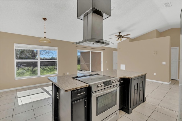 kitchen with lofted ceiling, light tile patterned floors, island exhaust hood, dark cabinetry, and electric stove