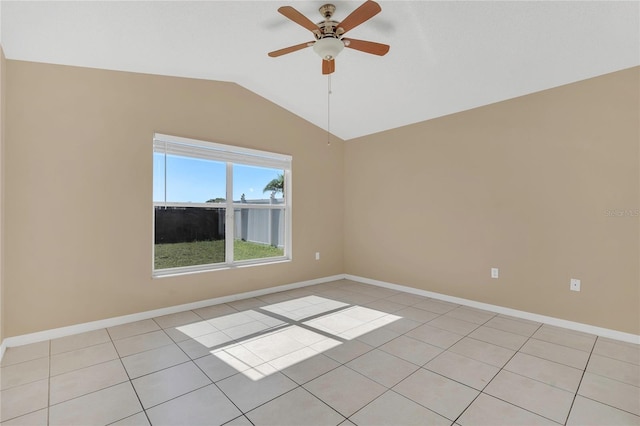 spare room with light tile patterned floors, baseboards, lofted ceiling, and ceiling fan