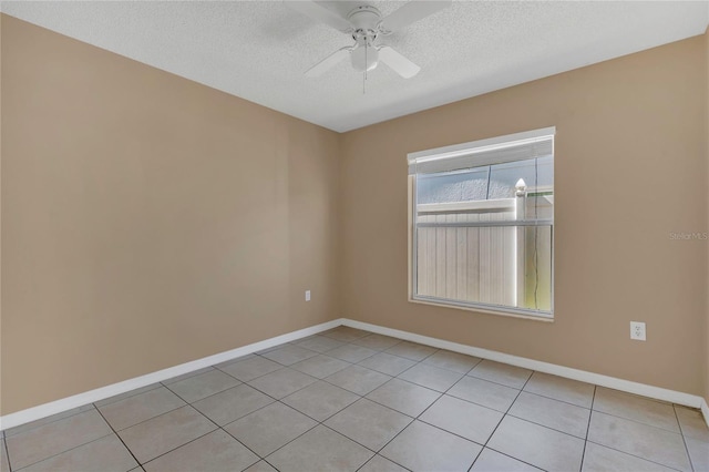 spare room with baseboards, a textured ceiling, ceiling fan, and light tile patterned flooring