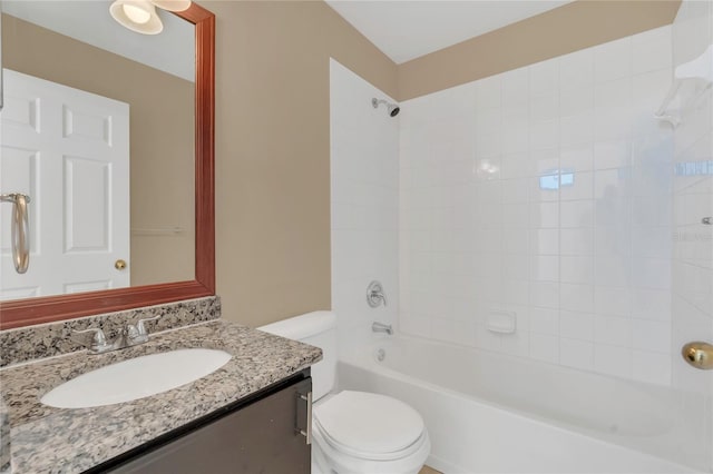 bathroom featuring shower / washtub combination, toilet, and vanity