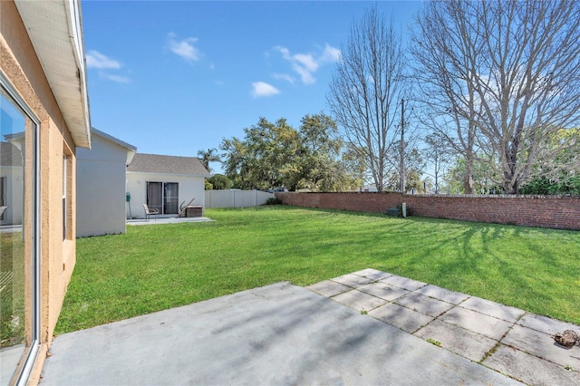 view of yard featuring a patio and a fenced backyard