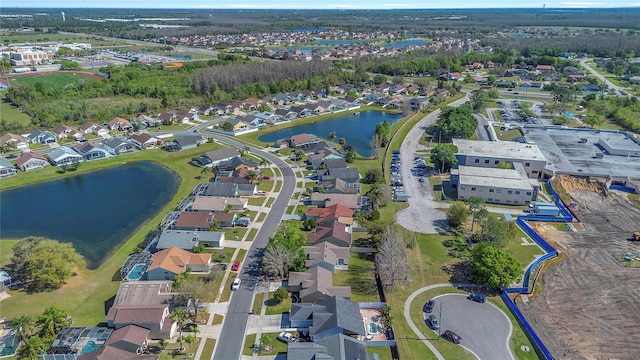 birds eye view of property featuring a residential view and a water view