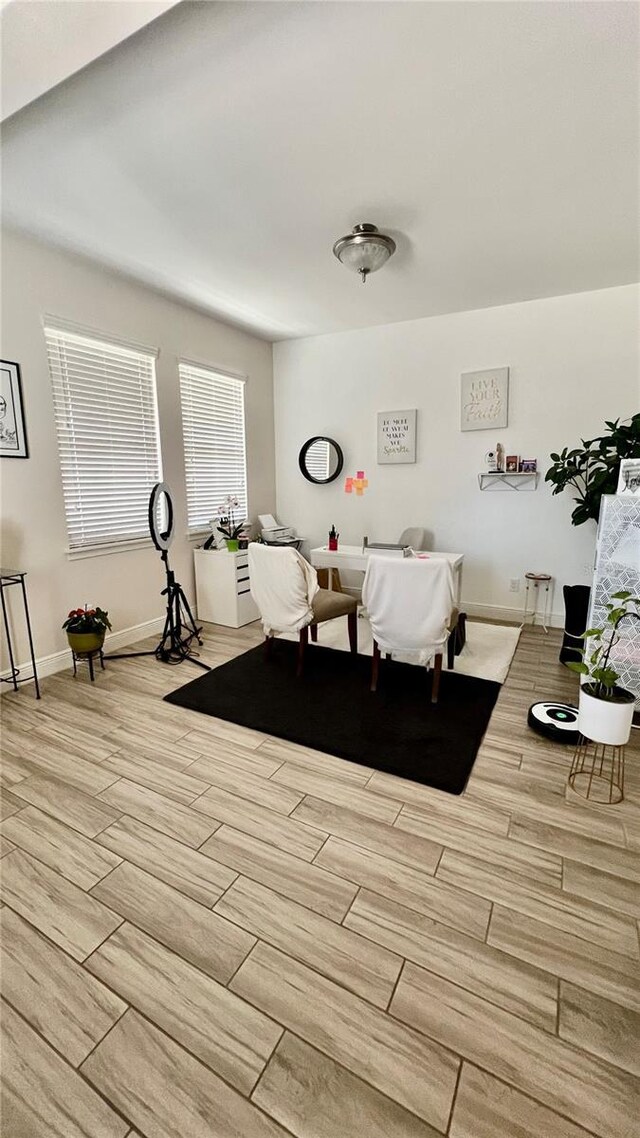 interior space with baseboards and wood finish floors