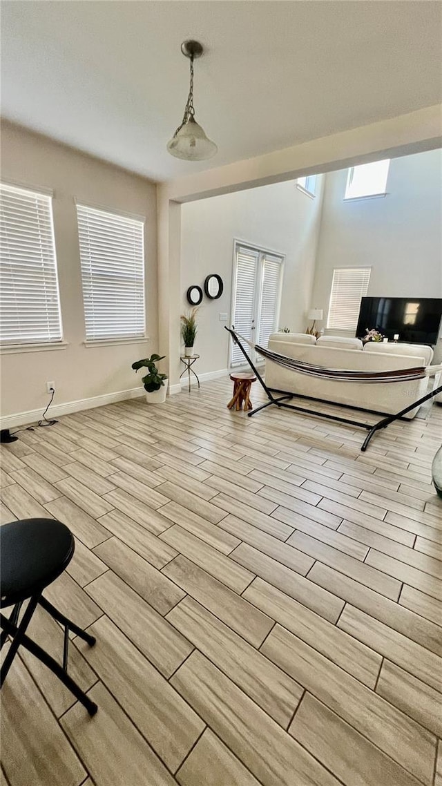 workout area featuring french doors, baseboards, and wood tiled floor