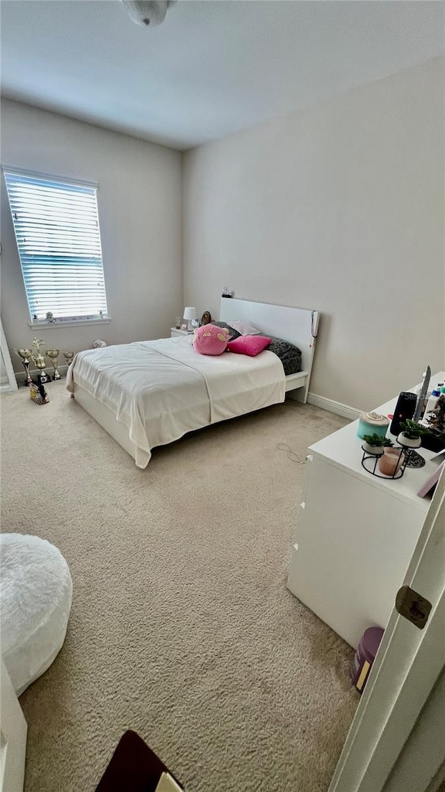 carpeted bedroom featuring baseboards