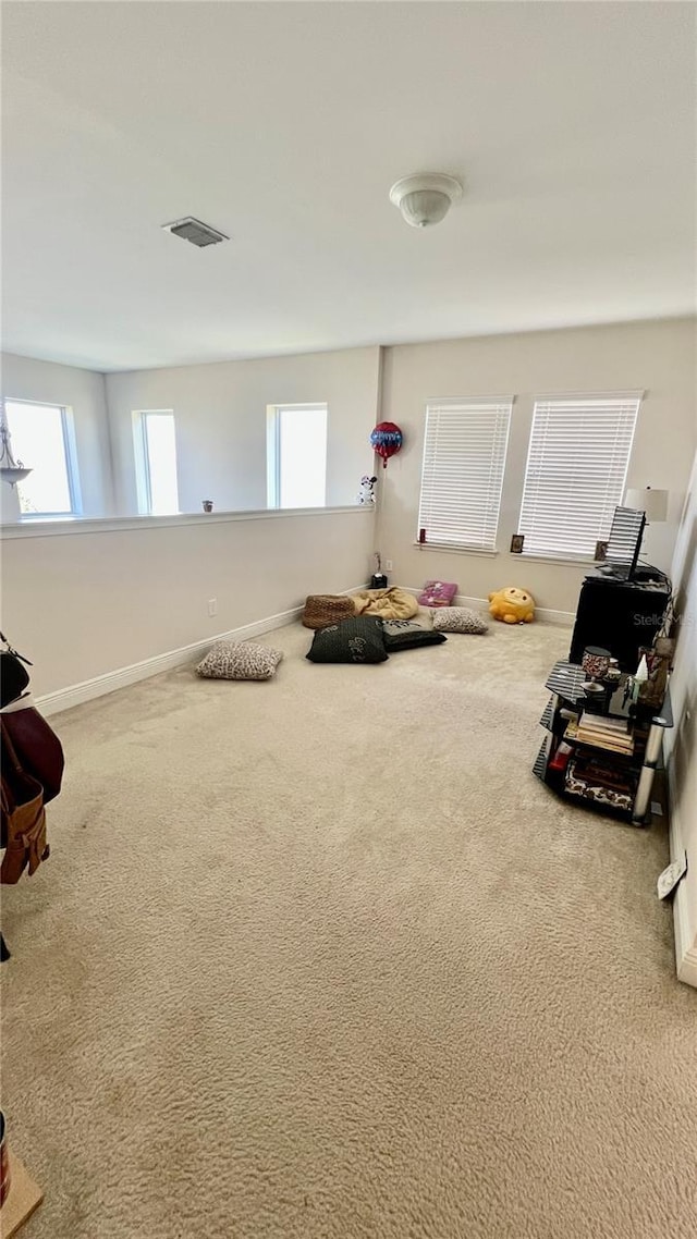 interior space with carpet, visible vents, and baseboards