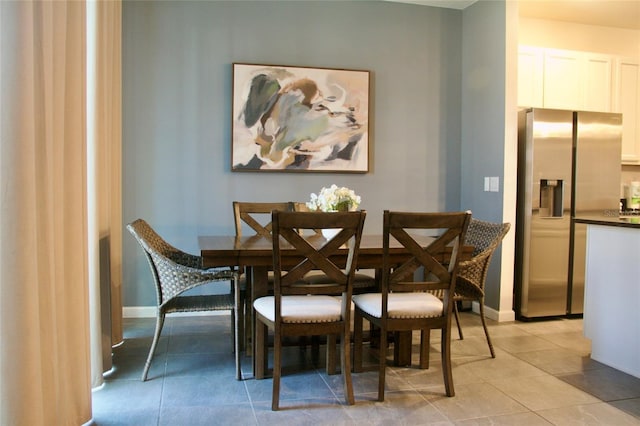 dining room with light tile patterned flooring and baseboards