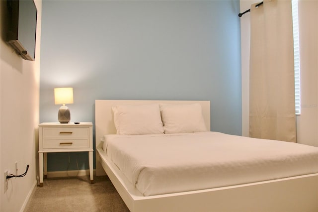 bedroom featuring baseboards and carpet flooring