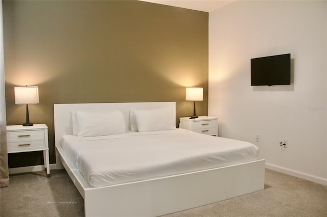 bedroom featuring baseboards and carpet