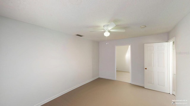 unfurnished bedroom featuring a ceiling fan, baseboards, visible vents, and a textured ceiling