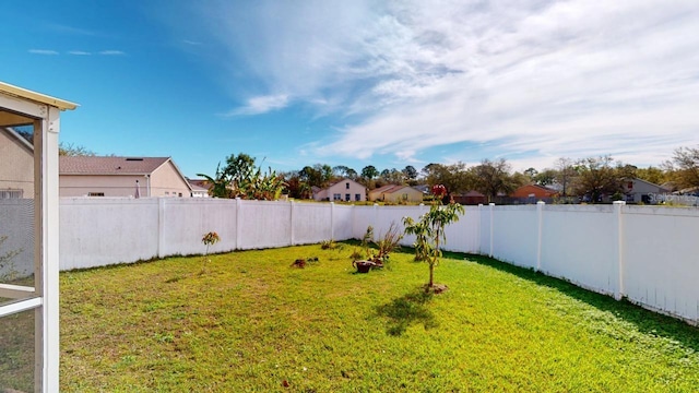 view of yard featuring a residential view and a fenced backyard