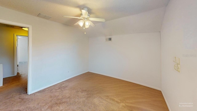 unfurnished room with visible vents, a ceiling fan, a textured ceiling, carpet floors, and baseboards