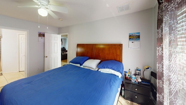 bedroom with tile patterned flooring, visible vents, and ceiling fan