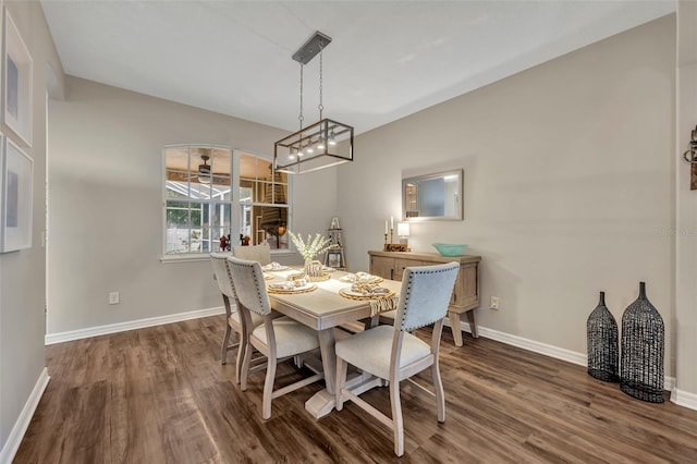 dining room featuring baseboards and dark wood-style flooring