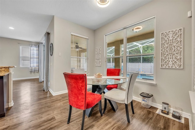 dining area featuring baseboards and wood finished floors