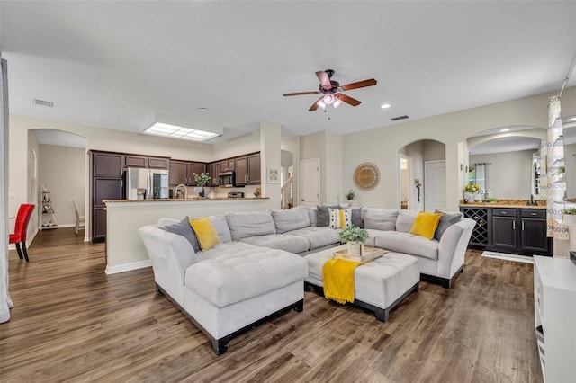 living room featuring recessed lighting, visible vents, baseboards, and dark wood-type flooring