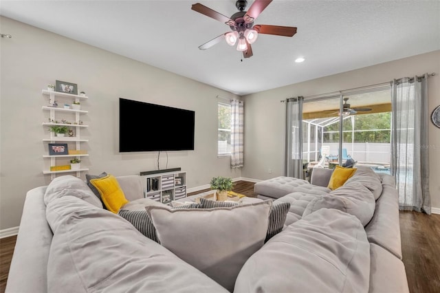 living area with recessed lighting, wood finished floors, baseboards, and ceiling fan