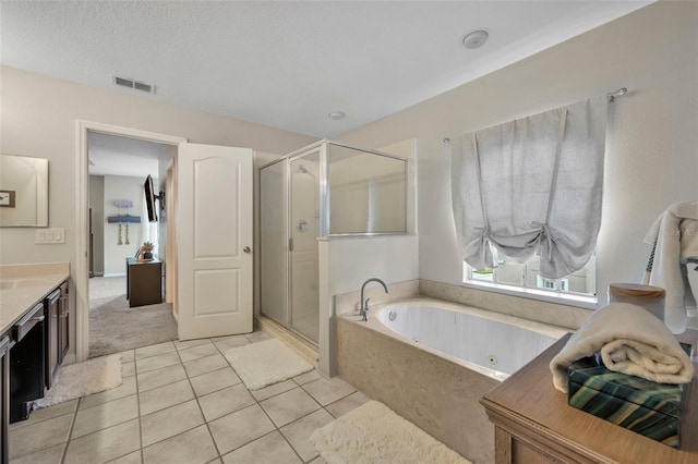 full bathroom with visible vents, vanity, a stall shower, and a whirlpool tub