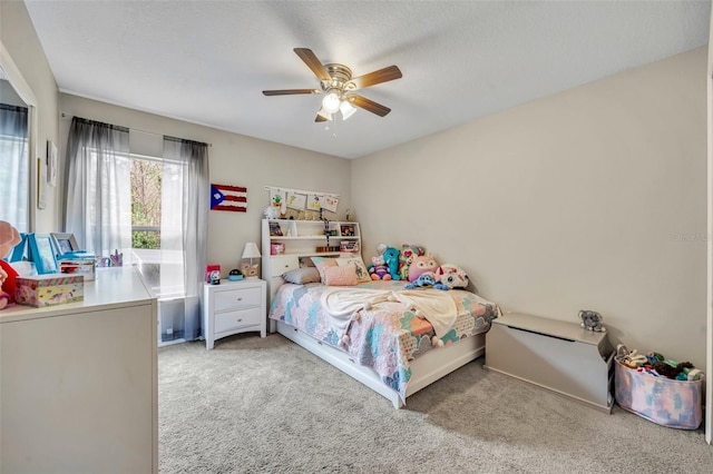 bedroom featuring carpet flooring, a textured ceiling, and a ceiling fan