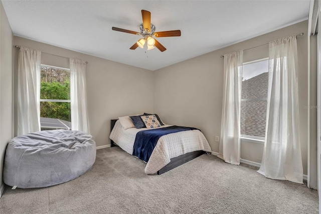 carpeted bedroom featuring ceiling fan and baseboards