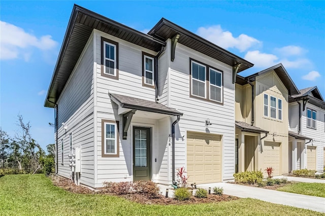 multi unit property with driveway, a front yard, and a garage