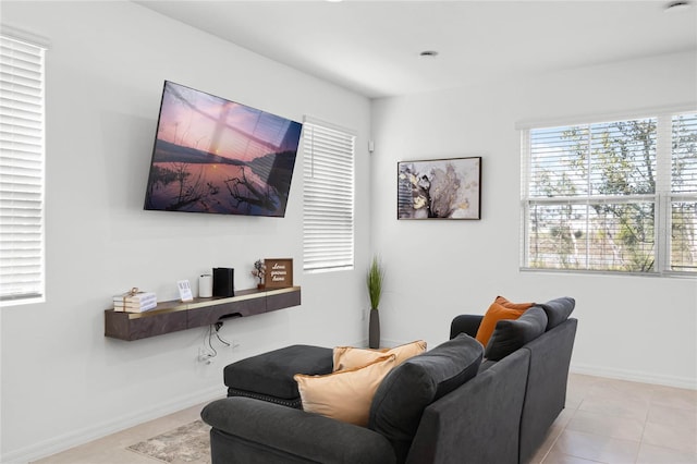 living room with light tile patterned floors and baseboards