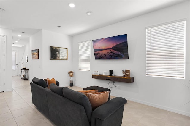 living area featuring recessed lighting, baseboards, and light tile patterned flooring